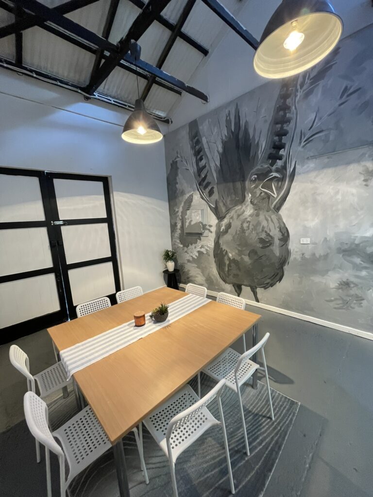 Studio 6 mural and pendant lighting above the table