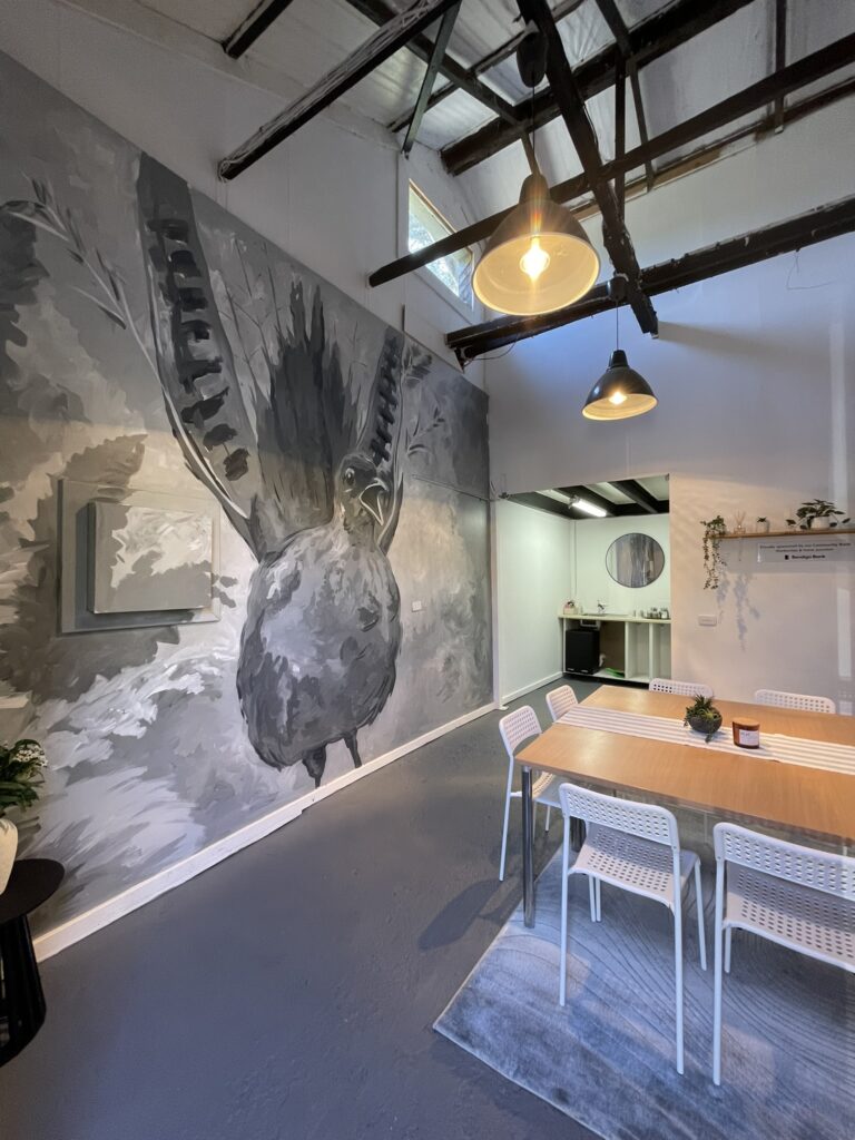 Studio 6 with its floor-to-ceiling bird mural, exposed timber beams and workshop table
